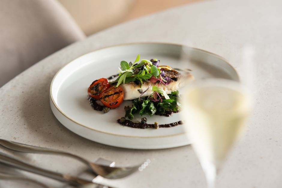 A gourmet dish featuring fish fillet with grilled vegetables