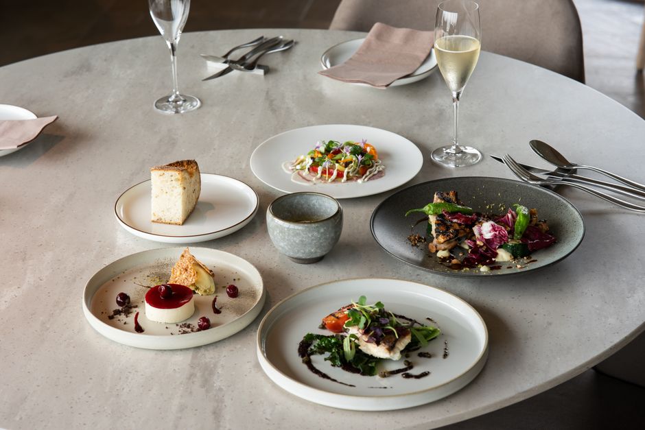 Elegant fine dining setup with gourmet dishes and wine