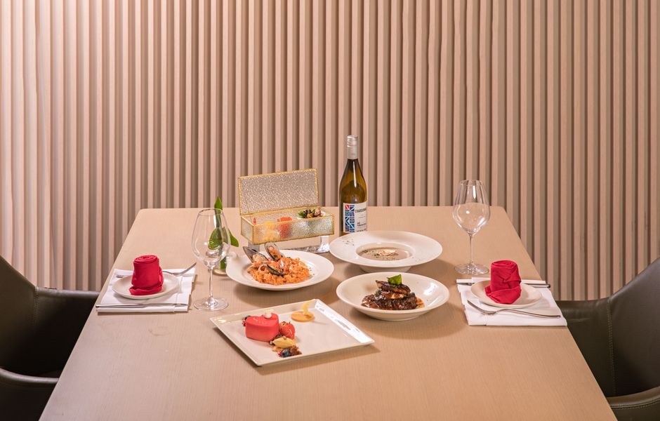 A beautifully arranged dining table with gourmet dishes, offering a fine dining experience