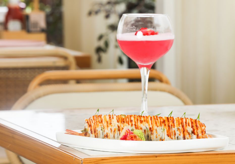 Elegant presentation of sushi paired with a vibrant cocktail