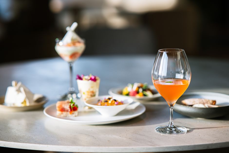 Gourmet dessert and cocktail arrangement on a stylishly set table, perfect for fine dining