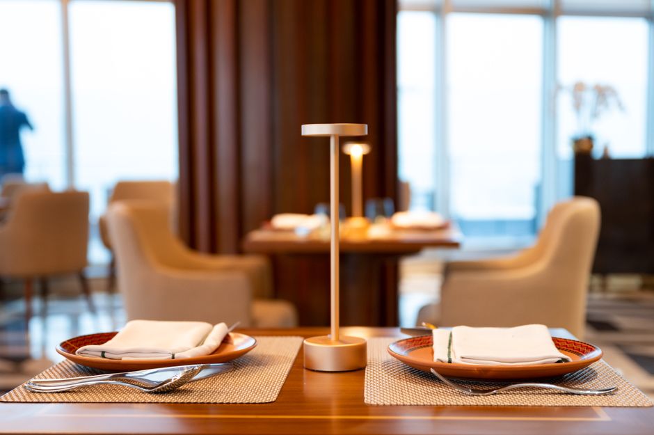 Luxurious restaurant table setting featuring modern table lamp