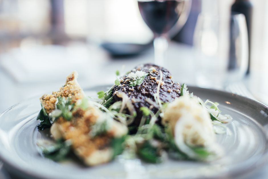 Tasty stuffed celery and grilled steak decorated with fresh green herbs served on plate
